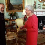 Tickled pink: The Queen sharing a laugh with poet John Agard yesterday at Buckingham Palace