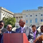 Bobby Rush at podium, falnked by Charlie Rangel, immediate left, Evette Clarke, far right