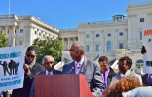 Bobby Rush at podium, falnked by Charlie Rangel, immediate left, Evette Clarke, far right
