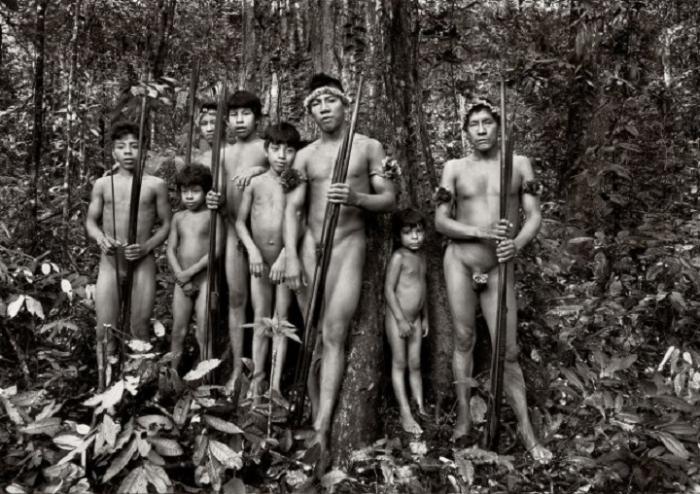 Standing Tall, Awá men and boys, in the Território Indígena Awá, in the Brazilian Amazon - Photograph by Sebastião Salgado
