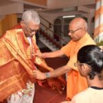 David Granger being draped with a shawl as he is welcomed by Principal of the Saraswati Vidya Niketan Secondary School