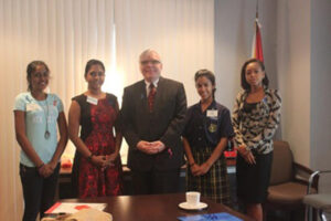 H. C. Giroux with top submissions for the social media competition. L-R: Sarah Mohan Nirmala Persaud, Rebecca Low, Kendra Warner