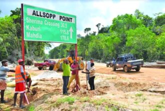 Contractors from the Public Infrastructure Ministry installing the new Allsopp Point sign  - Guyana Times Photo